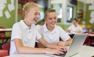 School children in front of computer